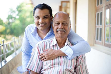 Son holding his father on a wheelchair at Starr Hospice end-of-life care