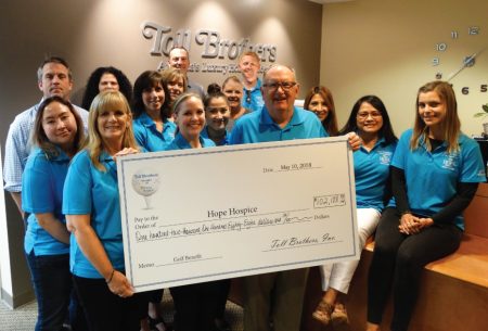 The Toll Brothers holding a check for $102,188 For Starr Hospice at charity Golf Castlewood Country Club