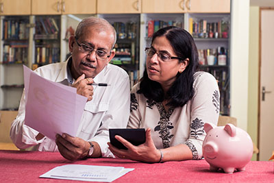 couple reviewing costs of in-home caregiving 