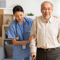 nurse helping elderly man