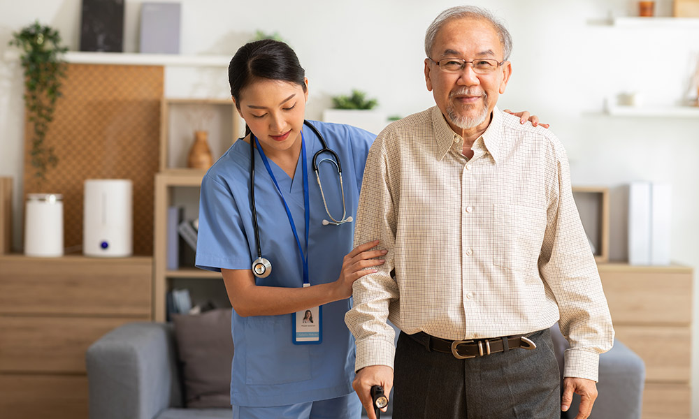 nurse helping elderly man